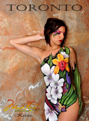 Woman body painted with bright flowers with the word Toronto above the image